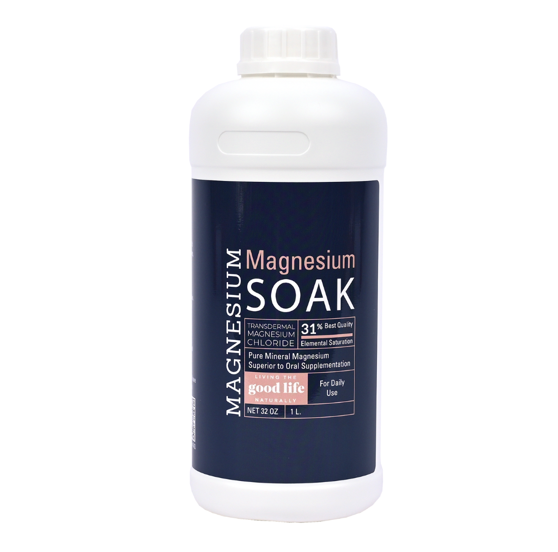 A white bottle with a screw-on cap featuring a blue label. The label reads "Magnesium, Magnesium Soak, Transdermal Magnesium Chloride, 31% Elemental Saturation, Pure Mineral Magnesium Superior to Oral Supplementation, For Daily Use, Net 32 OZ / 1L" with the Living the Good Life Naturally on a pink background.