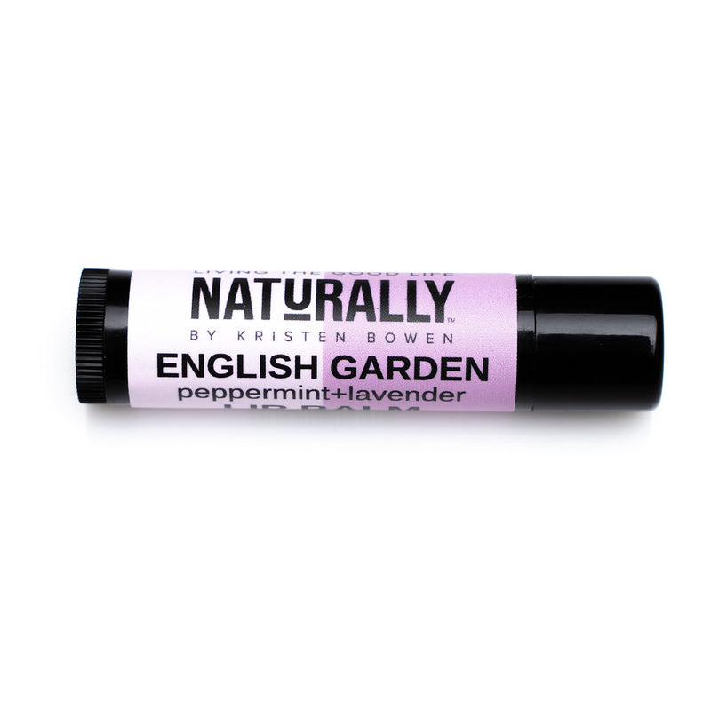 A brown lip balm tube with a light purple label. The label reads “Naturally by Kristin Bowen, English Garden, Peppermint+Lavender".