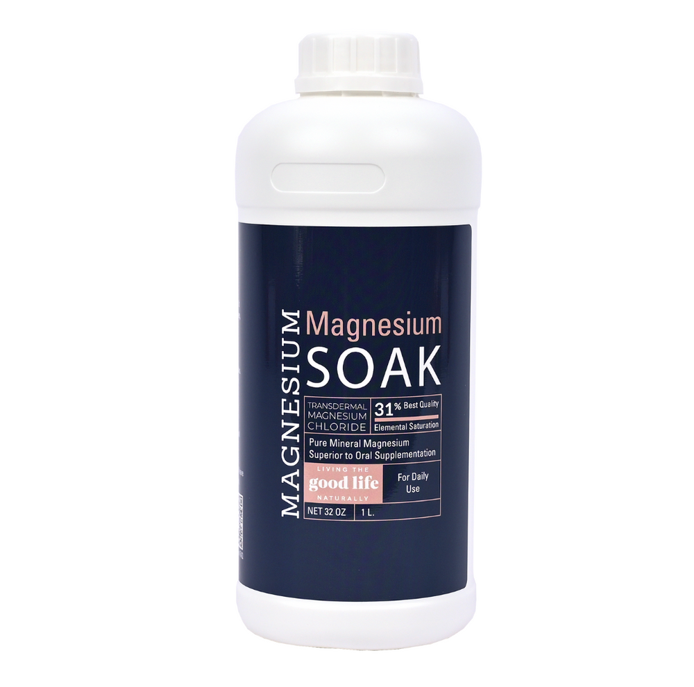 A white bottle with a screw-on cap featuring a blue label. The label reads "Magnesium, Magnesium Soak, Transdermal Magnesium Chloride, 31% Elemental Saturation, Pure Mineral Magnesium Superior to Oral Supplementation, For Daily Use, Net 32 OZ / 1L" with the Living the Good Life Naturally on a pink background.